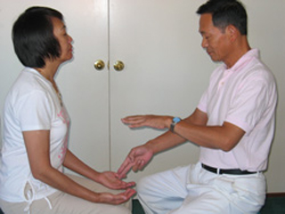 Master Ou was giving a one-on-one onsite healing session.